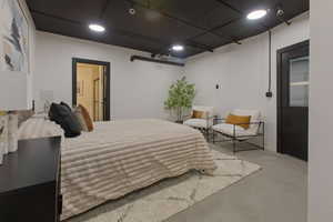 Bedroom featuring finished concrete floors