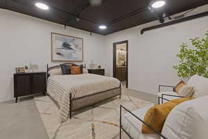 Bedroom with finished concrete flooring and ensuite bath