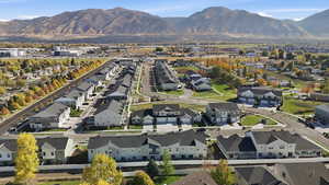 Aerial view of property's location featuring a mountain backdrop and nearby suburban area