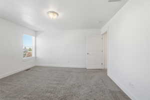 Spare room featuring light carpet