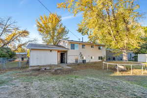 Rear view of property featuring a gate and a trampoline