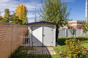 View of shed with a fenced backyard
