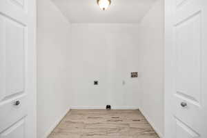 Laundry room with light wood-style floors, washer hookup, and electric dryer hookup