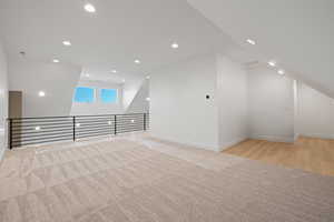 Bonus room with light colored carpet and recessed lighting