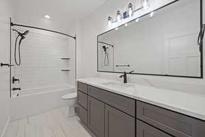 Full bathroom featuring vanity, bathtub / shower combination, and recessed lighting