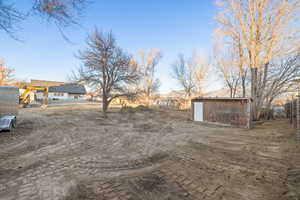 view from rear of property looking back toward the house. removable chicken shed in photo.