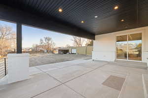 Patio terrace at dusk featuring a patio area and a residential view