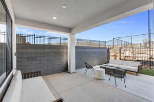 Fenced backyard with a patio and an outdoor hangout area