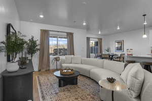 Living area with wood finished floors and recessed lighting