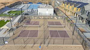 View of tennis court with a patio area and a pergola