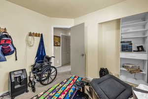 Recreation room featuring carpet flooring and baseboards