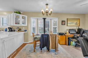 Dining space with healthy amount of natural light, an office area, and a chandelier