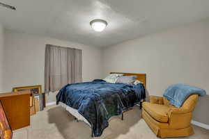 Carpeted bedroom with baseboards