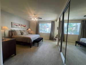 Master  bedroom Carpeted bedroom with a closet and a ceiling fan