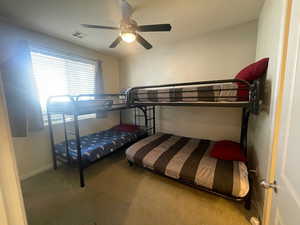 Bedroom with carpet flooring and ceiling fan