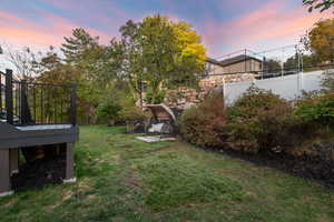 Yard at dusk featuring a fenced backyard