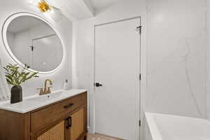 Bathroom with vanity and a bathtub