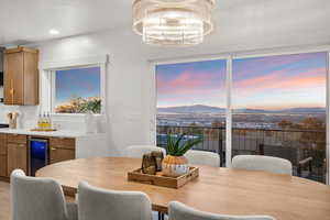 Dining room featuring a mountain view, recessed lighting, a chandelier, and beverage cooler