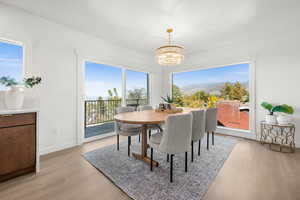 Dining space with light wood-style floors, a chandelier, and a mountain view
