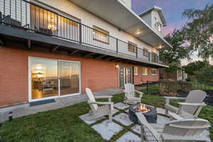 Patio terrace at dusk featuring a balcony and a patio