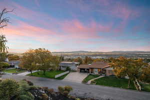 Aerial view of property and surrounding area featuring mountains