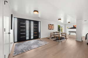 Foyer entrance featuring light wood finished floors, french doors, and a textured ceiling