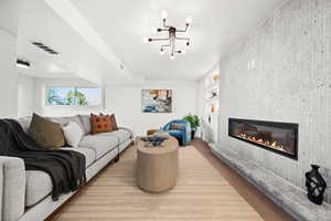 Living area with a tiled fireplace and light wood-style floors