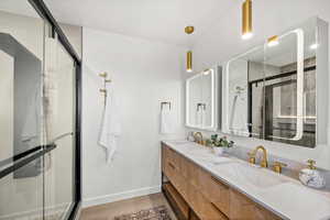 Full bath with a stall shower and double vanity