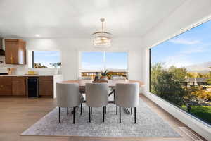 Dining space featuring light wood-style floors and wine cooler