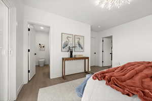 Bedroom with wood finished floors and ensuite bathroom