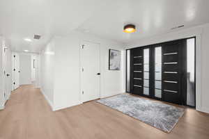 Foyer featuring light wood-style flooring