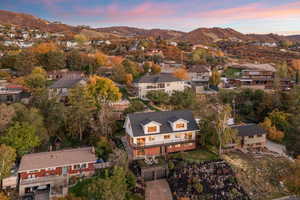 Aerial view of property's location featuring a mountainous background and nearby suburban area