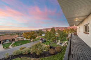 View of yard with a balcony and a mountain view