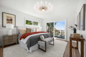 Bedroom with access to exterior and wood finished floors