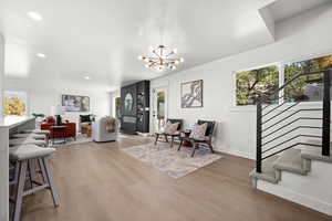 Dining room featuring light wood-style flooring, plenty of natural light, recessed lighting, and a chandelier