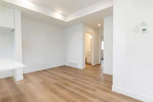Empty room featuring light wood finished floors and recessed lighting