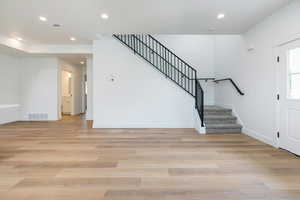 Foyer featuring recessed lighting, stairs, and light wood finished floors