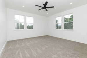 Empty room featuring light carpet, recessed lighting, and a ceiling fan