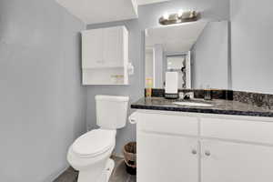 Bathroom featuring vanity and toilet