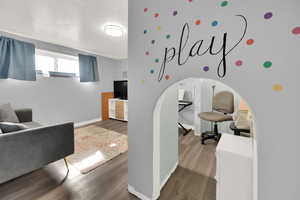 Living room featuring wood finished floors and a textured ceiling