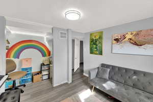 Office area with a textured ceiling and wood finished floors