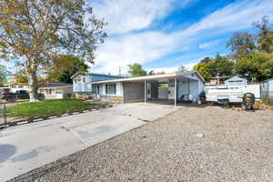 Split level home with driveway and an attached carport
