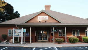 View of  HOA building exterior featuring uncovered parking