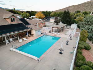Community pool with a patio area and a gazebo