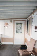 View of exterior entry featuring a sunroom