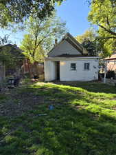 Rear view of house featuring a chimney