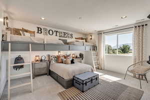 Carpeted bedroom featuring recessed lighting and a mountain view