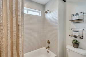 Bathroom with shower / tub combination and toilet