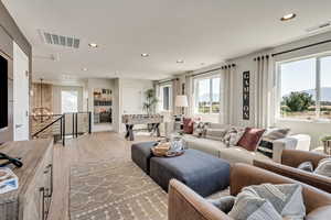 Living area with light wood-type flooring, recessed lighting, and a mountain view
