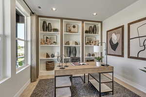 Office space featuring light wood finished floors and recessed lighting